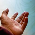 persons left palm over white textile